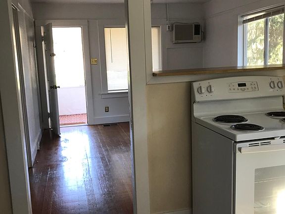 looking from kitchen through living room and out front door