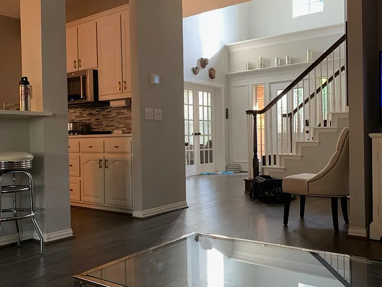 Open floorplan connecting entrance, main living area and kitchen