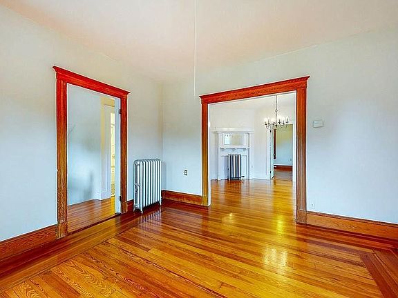 Living room with view of dining room and 2nd floor hallway