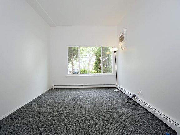 Living Room with large window and AC unit