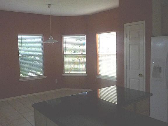 View from Kitchen showing granite counter and viewing into the breakfast view.