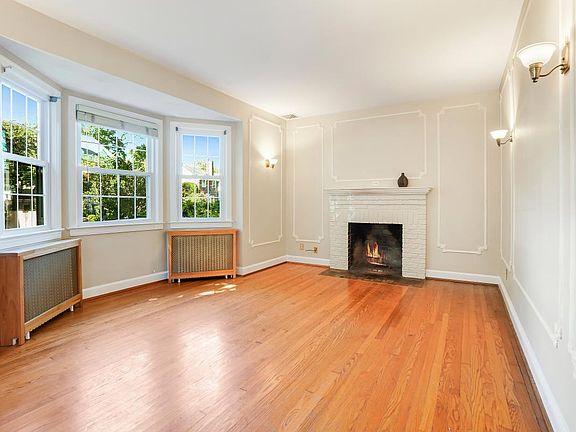 Living Room with Original Moldings, Sconces, Fireplace, a Bay window plus another south facing window. Measures approximately 10'10" X 17'4"