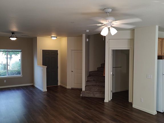 Living room looking to entrance, dining room, stairwell, half bath