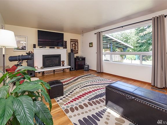 Living room has hardwood floors and gas fireplace