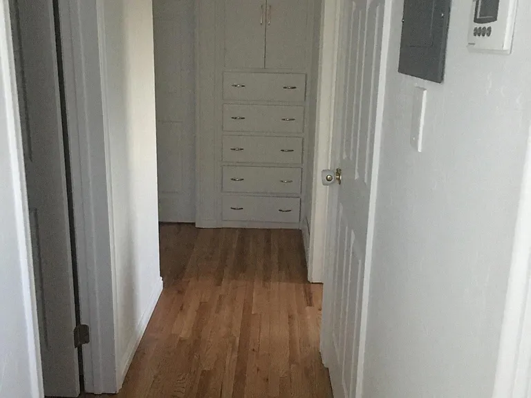 Hallway - built in storage. Door on the right goes to basement.