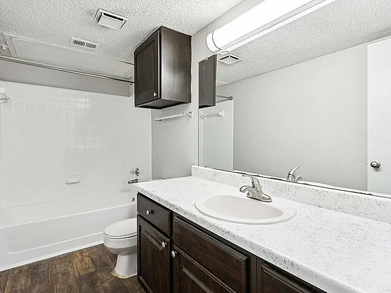 Enjoy a bright, modern bathroom with updated fixtures at Collin Creek Apartments.
