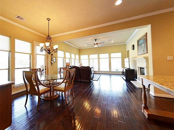 Walls of windows on two sides offer a wonderful view of the custom-built pool, spa, and huge deck area.