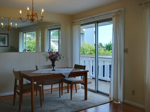 Lovely sound & mountain views from living and dining rooms! These rooms also feature new laminate hardwood floors & fresh paint... and there is a large, wrap-around deck off the dining room.