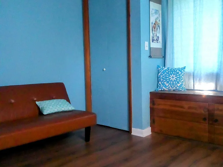second large bedroom with eleven foot ceilings, canopy bed,
 and futon. View from the canopy bed.
