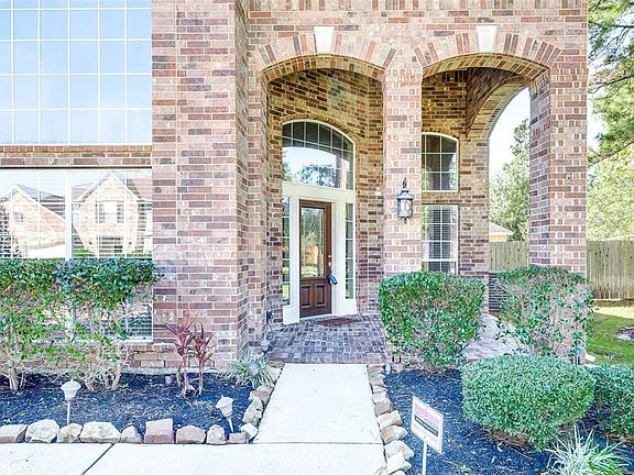 High arched entrance with bricked front porch takes you to the leaded glass front door.