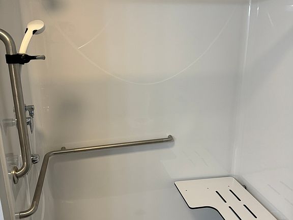 Walk in shower with folding seat
