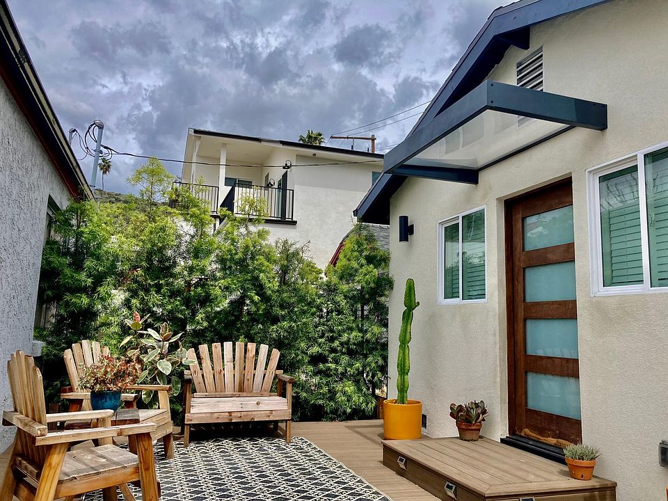 Front deck by Trex Decking. Private, spacious, with a full size natural fence with Podocarpus hedges.