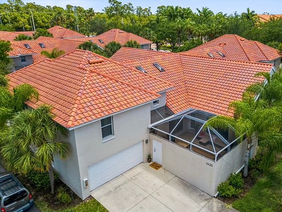 Rare courtyard villa overlooking the water, featuring a private screened courtyard and attached two-car garage.