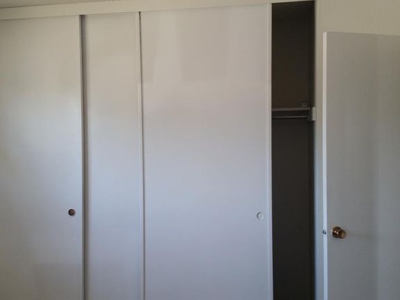 bedroom with 3 panels closet