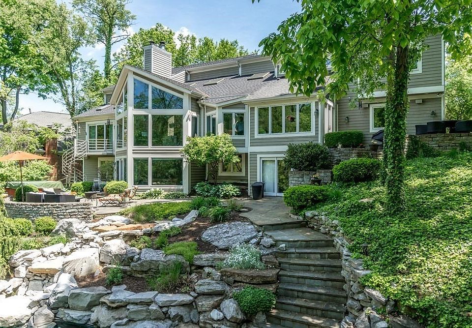 Gorgeous back yard with masonry, multiple patios, spiral stairs from master bedroom to hot tub and inground pool with waterfall.
