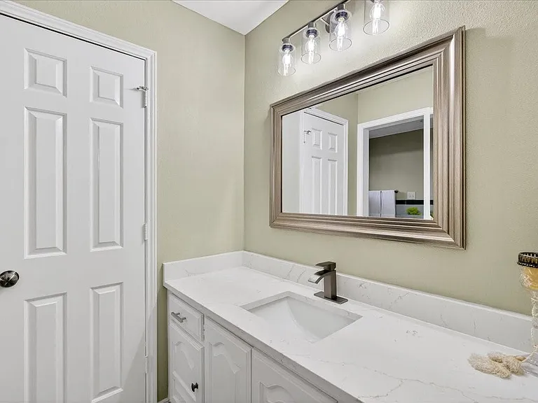 Dual vanity areas, New quartz countertops, sinks, hardware, mirrors and faucets.