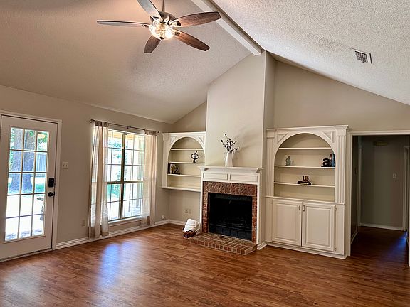 Open concept living room. Door opens to patio.
