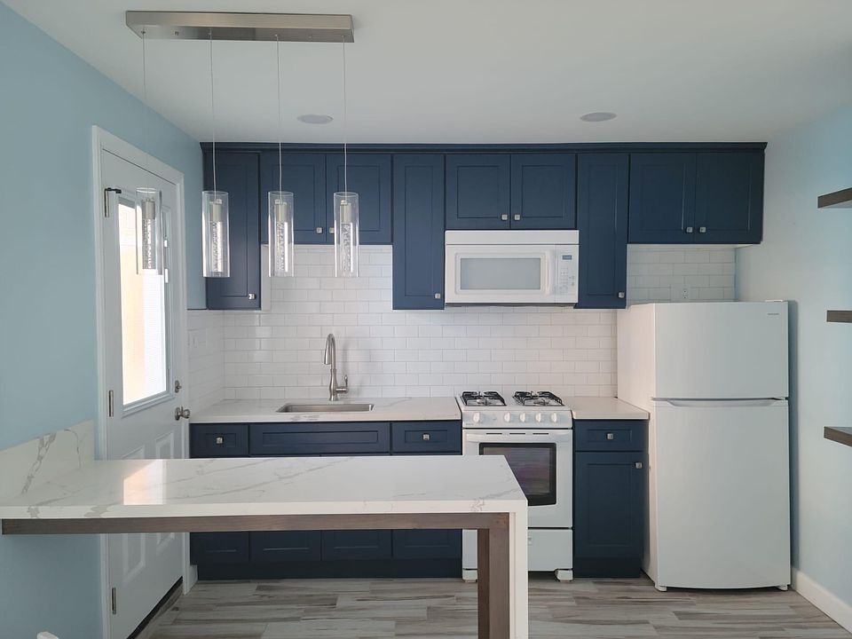 Modern & stylish kitchen includes brand new microwave, stove and refrigerator.