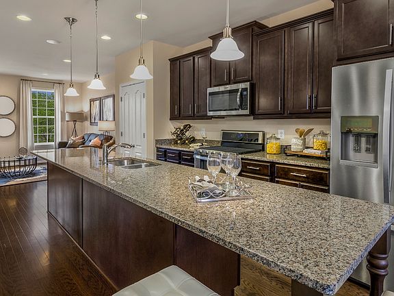 Center kitchen with large island in a DRB Homes Alden II model at the Parkside at Westphalia communi