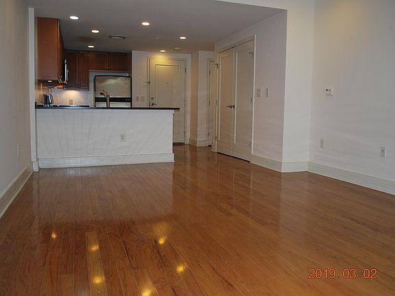 Living room facing kitchen and front door