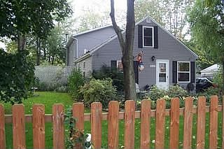 Lush landscaping surrounds this home on a fenced double lot.