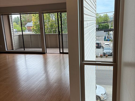 living room as seen from dining area. Separate dining area is off kitchen next to living room.