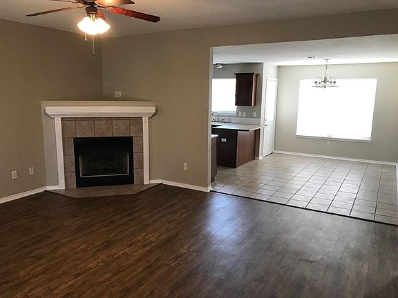 Den area leading into dining area and kitchen area.