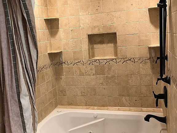 Custom travertine jetted tub