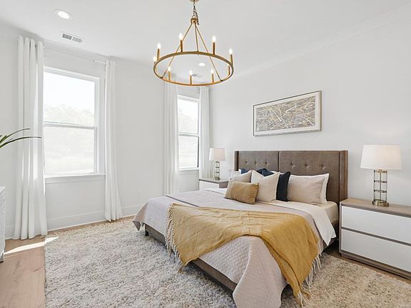 Luxurious first-floor primary bedroom suite with walk-in closet
