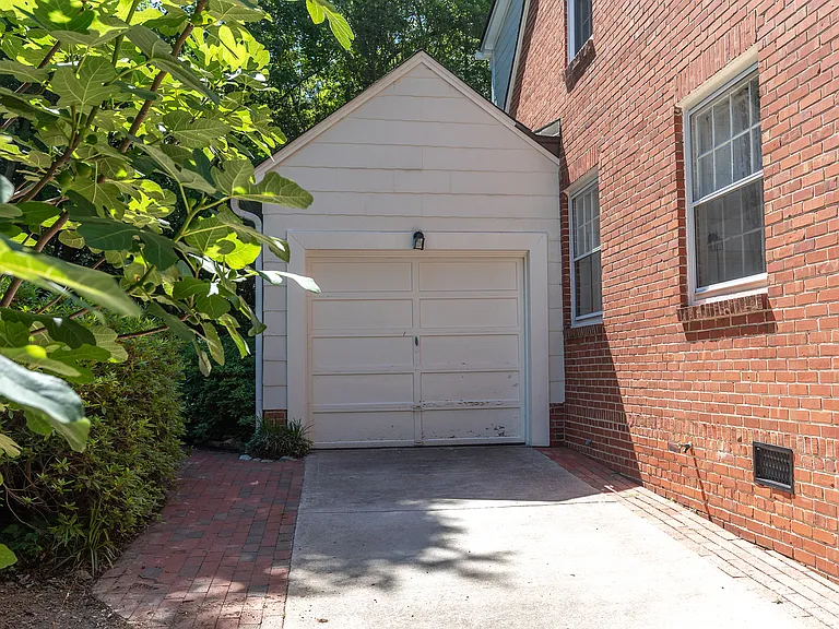 Small attached garage has full fridge and workbench.