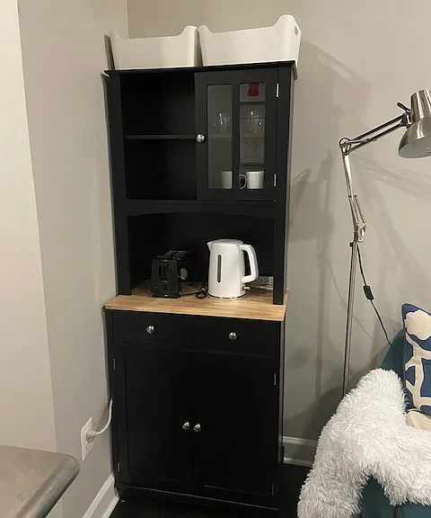 Breakfast beverage center. 2 slice toaster, hot water pot, wine glasses, coffee mugs, offering additional storage