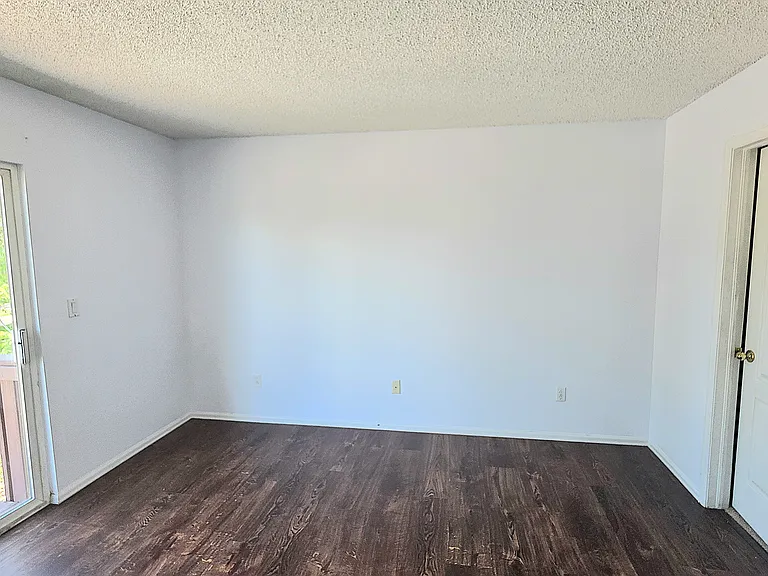 Primary bedroom as seen from en-suite full bathroom