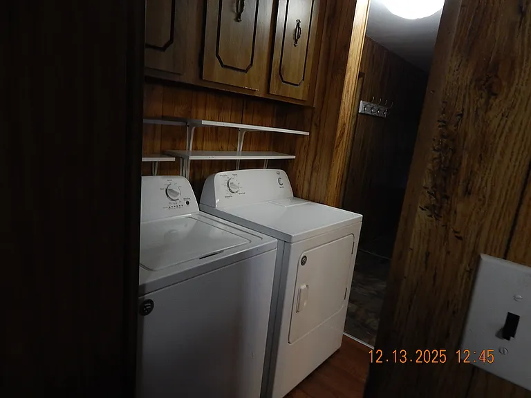 Washer and dryer with cabinet above.
