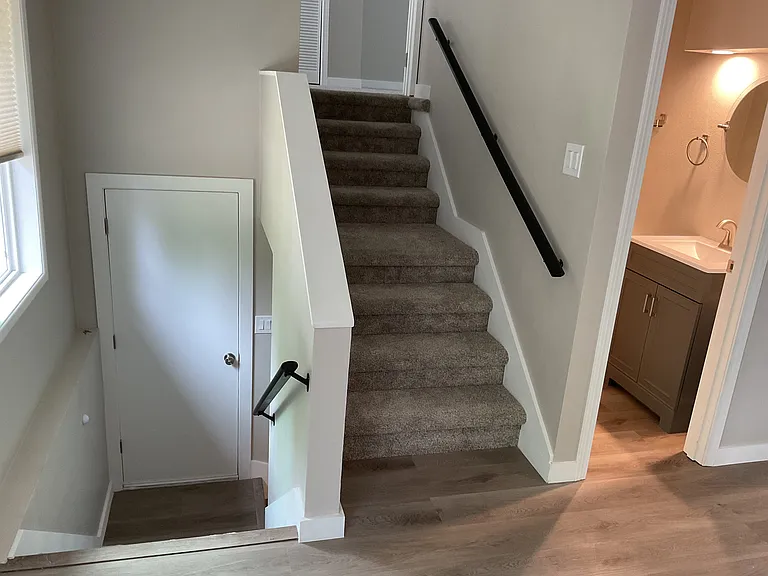 Stairs to garage door and lower bedrooms on the left, convenient entrance into house from attached garage