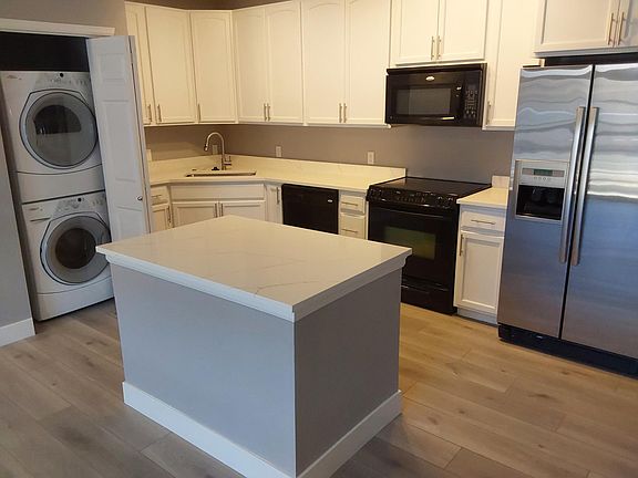 Closer view of new kitchen with washer/dryer closet to the left.