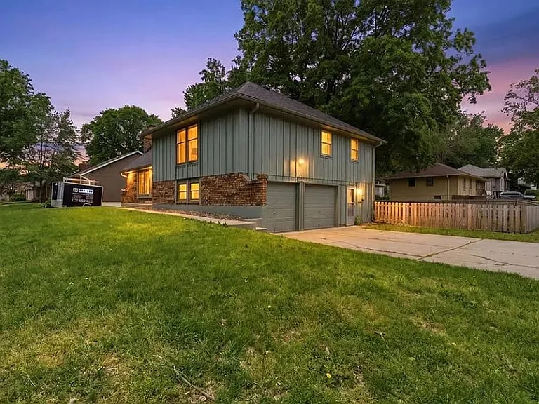 Stunning evening view highlighting the home's warm lighting, spacious layout, and quiet residential setting ideal for families, groups, and extended stay guests.