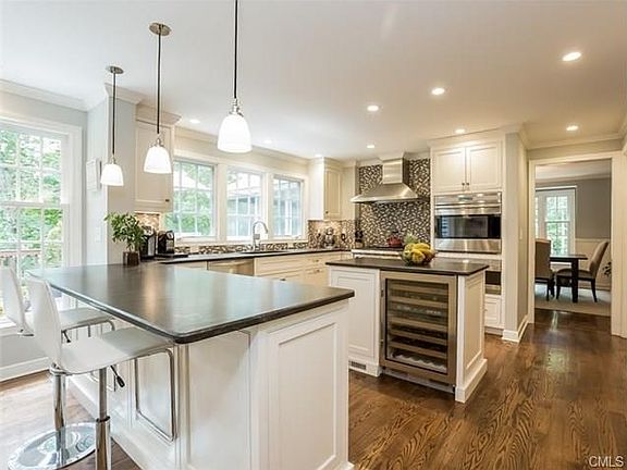 Gorgeous new kitchen with Wolf range and wall oven, Sub Zero refrigerator, breakfast bar, and center