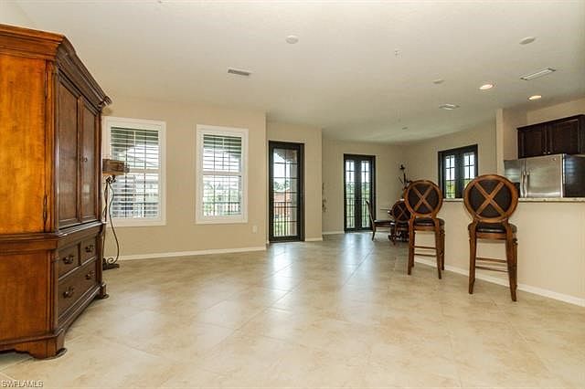 Beautifully tiled Great Room with French Doors and Breakfast Bar.