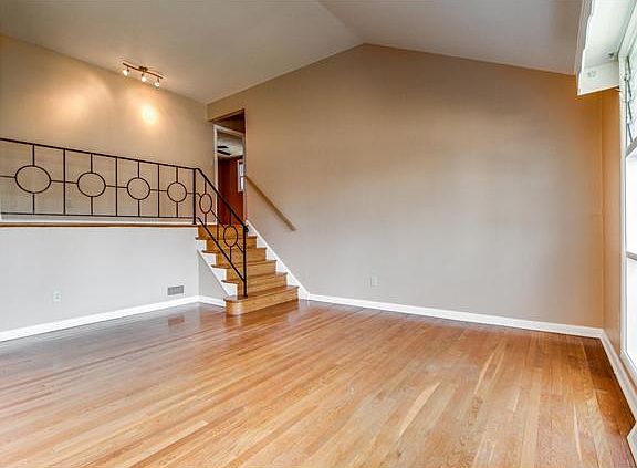 Neutral paint and recessed lighting in living room
