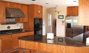 Kitchen w/granite countertops and custom cherry cabinets