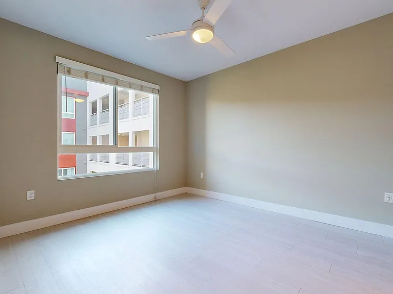 Spacious apartment Bedroom with Wood-Style Flooring.