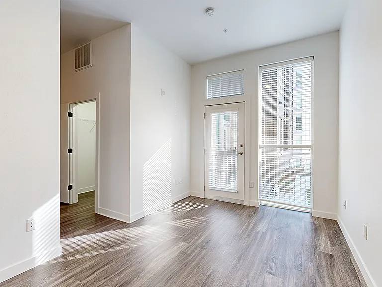 Apartment living room with wood-style flooring and balcony or patio.