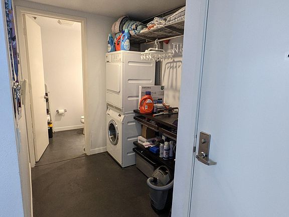 Laundry room near front door with built-in storage