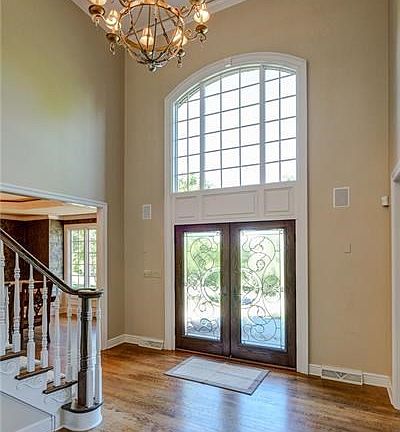 Elegant 2 story foyer with gorgeous hardwood floors and custom mill work which continues throughout most of the first floor.