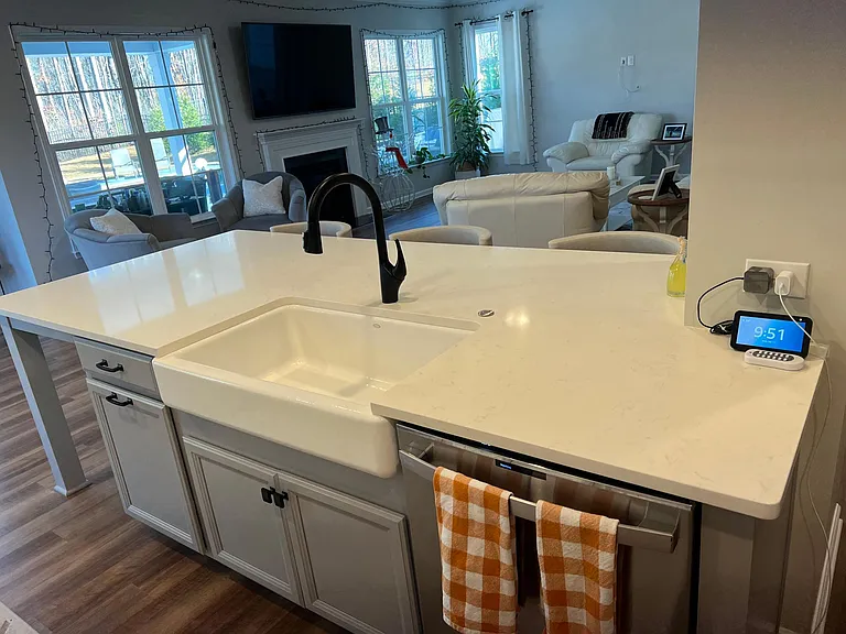 Large quartz entertaining island with barstools.