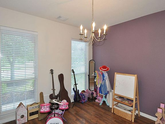 Dining room currently used as a play room. If you enclose it with French doors for minimal costs, yo