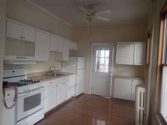 beautiful floors, lots of windows in kitchen, high ceilings with ceiling fan.