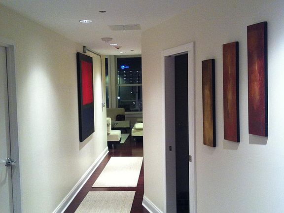 Hallway between the kitchen and the living room. The elevato