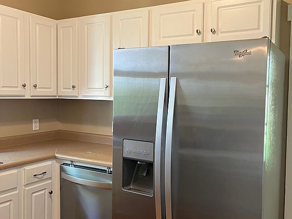 Kitchen cabinets, refrigerator, and dishwasher