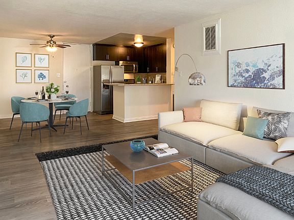 Living room, dining area, and kitchen at Mediterranean Village Apartment Homes